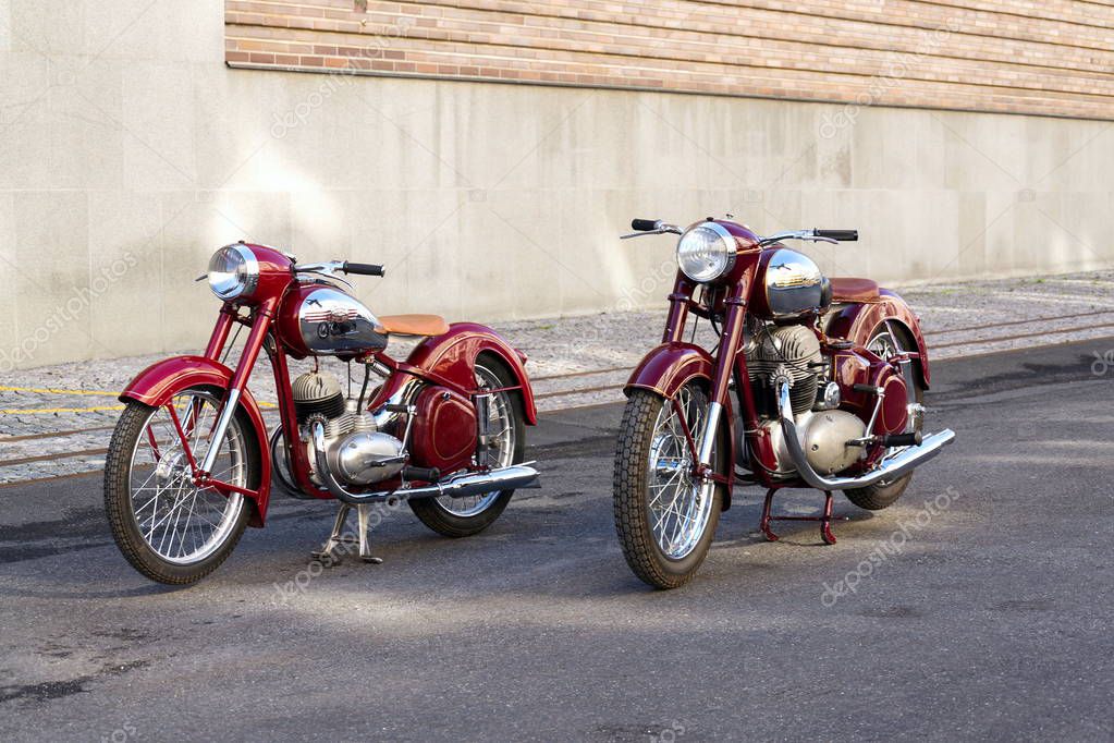 PRAGUE, CZECH REPUBLIC - MARCH 8 2018: Red vintage motorcycles Jawa 125 and Jawa 500 produced in former Czechoslovakia stand on road on March 8, 2018 in Prague, Czech Republic.