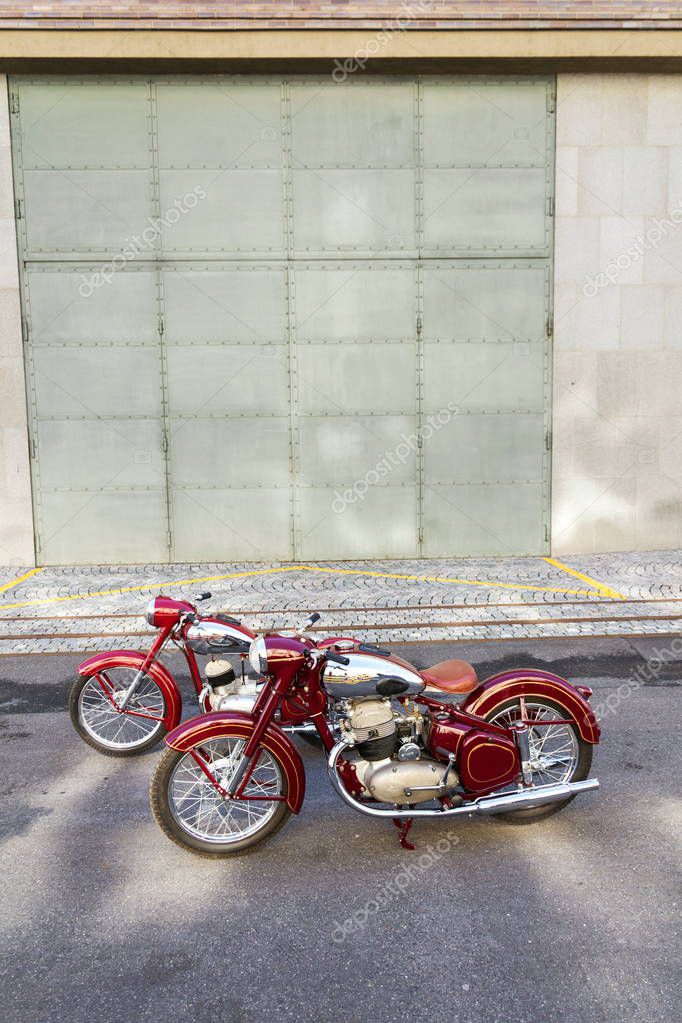 PRAGUE, CZECH REPUBLIC - MARCH 8 2018: Red vintage motorcycles Jawa 125 and Jawa 500 produced in former Czechoslovakia stand on road on March 8, 2018 in Prague, Czech Republic.