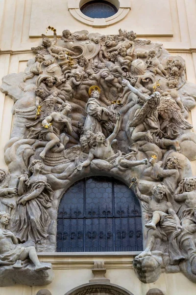 Relief sculpture on facade of the Church of Saint James The Greater with Minorite monastery in Old Town of Prague, Czech Republic, sunny day