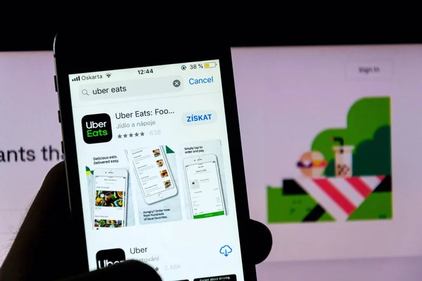 Prag, Tschechische Republik - 21. November 2018: uber isst das Logo des Lebensmittellieferanten auf dem Handy-Bildschirm mit Internet-Startseite im Hintergrund am 21. November 2018 in Prag, Tschechische Republik. — Stockbild Prag Tschechische Republik November 2018 Uber Isst Das Logo Des — Stockfoto