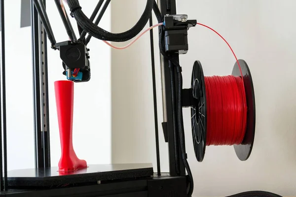 3d printer printing plastic last shoe prototype from red filament