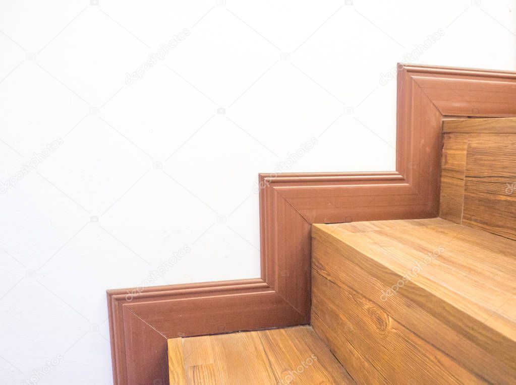 White background with a brown staircase that perfectly matches 