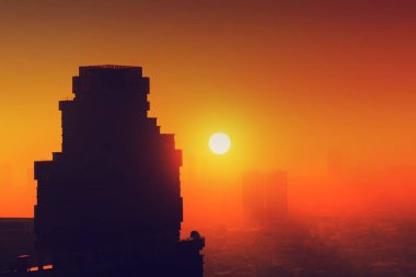 Batan güneşin arka planda bir gökdelen silueti