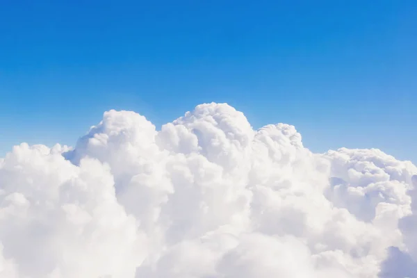 White fluffy clouds against a blue sky