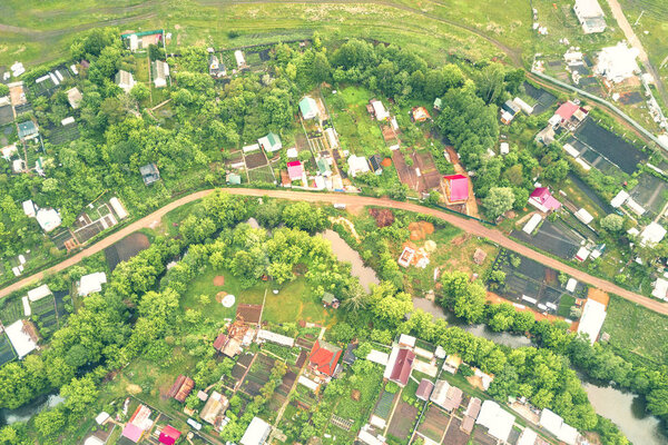 A winding river through a cottage village, top view