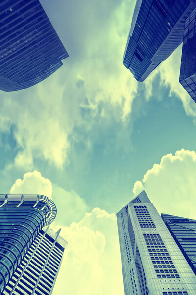 Bottom view of modern skyscraper. Business district. Toned