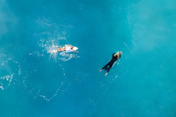 Two Surfers in the ocean, top view