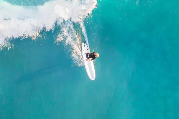 Surfer in the ocean, top view