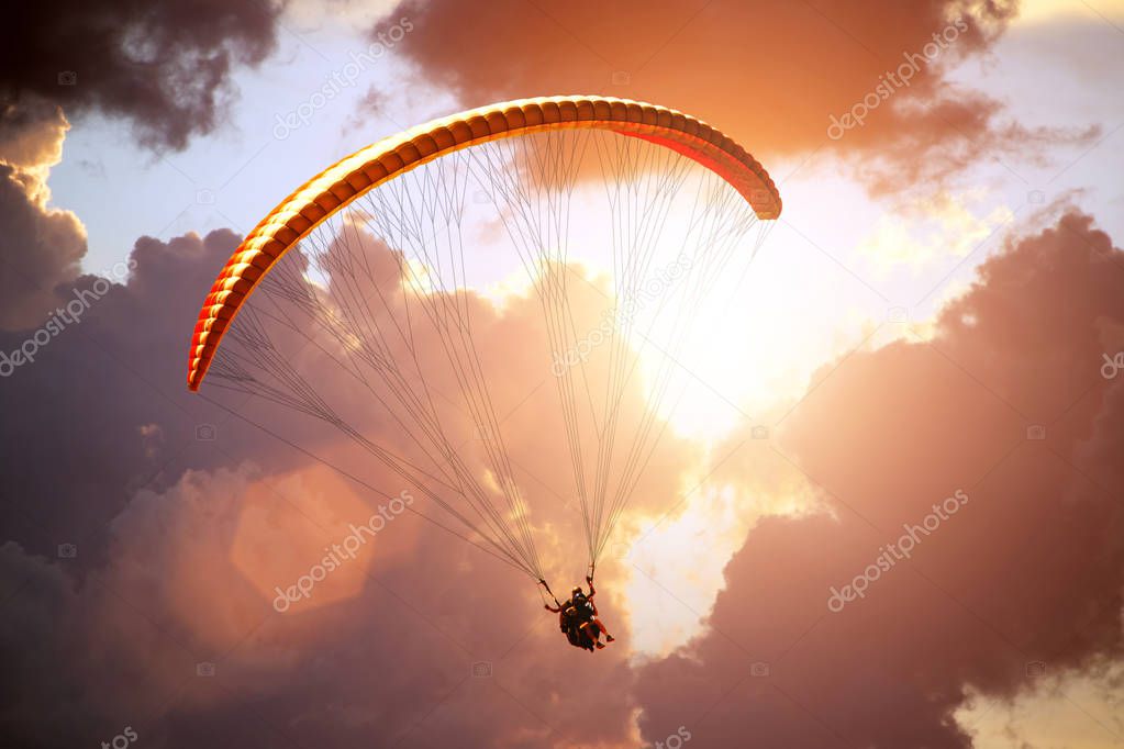 Paragliding in the sunset sky