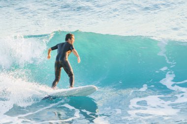Bogliasco, Italy, October 6, 2017:  Surfer stand on a surfboard and ride on a wave