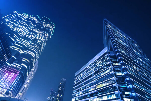 A modern night city. Skyscrapers with blue illumination