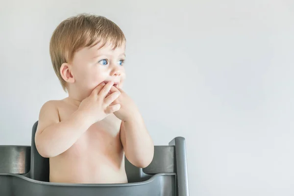 Portrait Blonde Blue Eyed Baby Boy Sitting Table Fingers Mouth — Stock Photo, Image