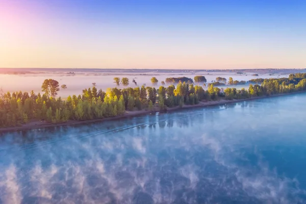 Fog over the river at sunrise, top view