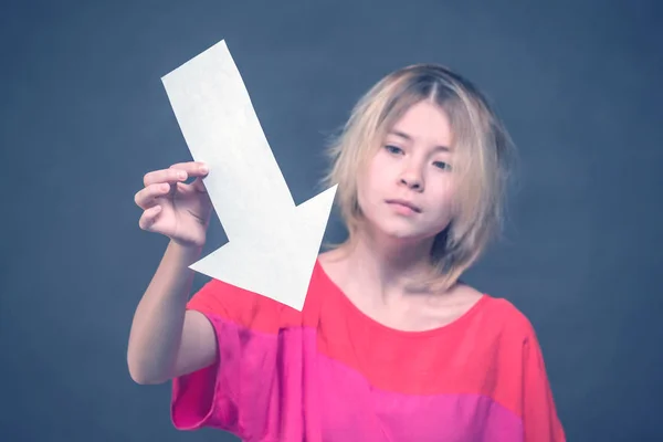 Blonde Girl Teenager Red Blouse Holding White Arrow Pointing — Stock Photo, Image