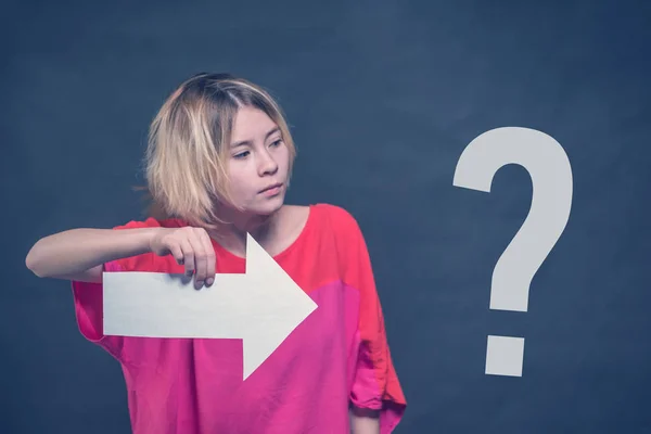 Blonde Girl Teenager Red Blouse Holding White Arrow Pointing Question — Stock Photo, Image