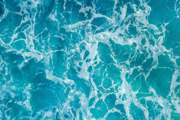 Surface of water with white foam, sea texture, ocean background