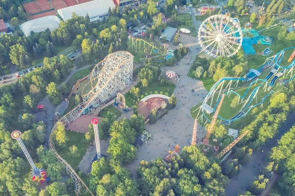 Ferris wheel and roller coaster in an amusement park, top view