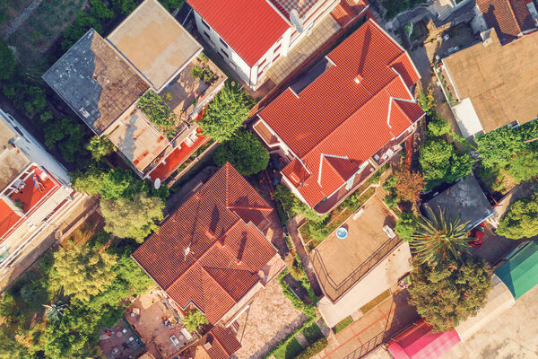 Red tiled roofs of houses, top view