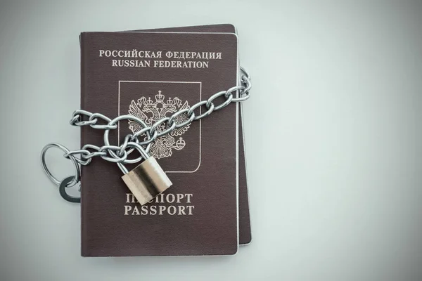 Russian Passports covered with a chain with a golden Lock. Toned