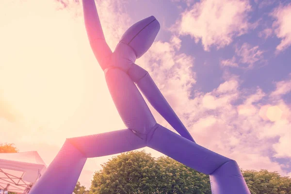 Blue Inflatable Air Dancer in the sunlight outdoors