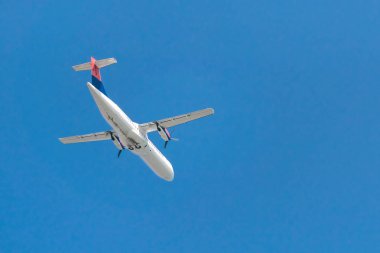 Mavi gökyüzünde uçan uçak