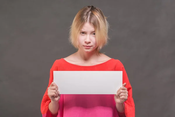 Skeptic Blonde Girl Teenager Red Blouse Holding Blank White Poster — Stock Photo, Image