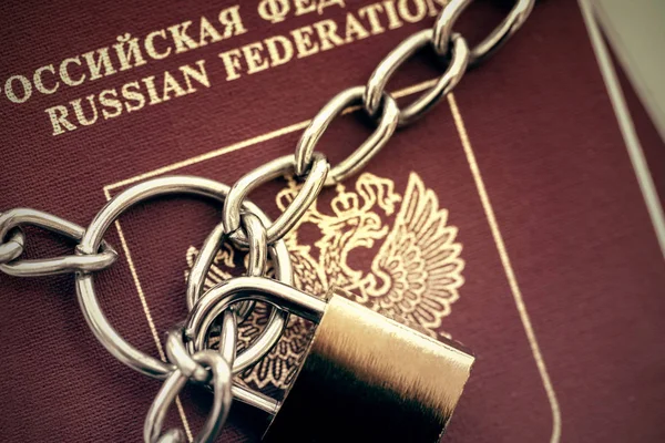 Russian Passports covered with a chain with a golden Lock. Toned