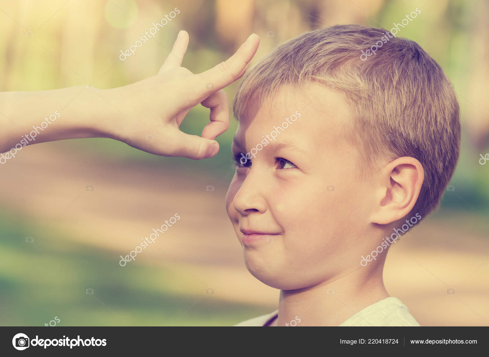 Blond Boy Waiting Flick Finger Forehead Stock Photo by ©watman