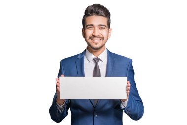 Beyaz bir arka plan üzerinde beyaz bir işaret tutan mavi elbiseli Genç çekici adam. İzole