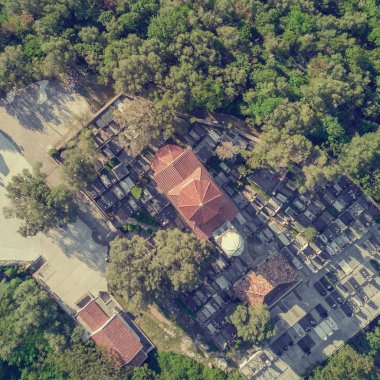 Kırmızı kiremitli çatılı taş church yakınındaki mezarlık üstten görünüm