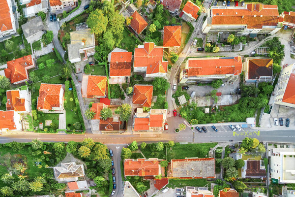 Top view of street in the old European city. Houses with red-tiled roofs