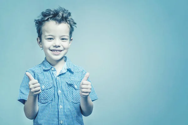 Smiling Boy Blue Shirt Showing Thumb Blue Background Toned — Stock Photo, Image