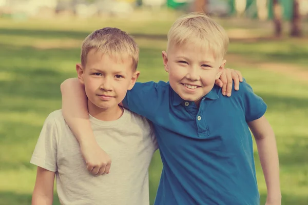 Két Szőke Fiú Fehér Kék Póló Állandó Átölelve Nyári Parkban — Stock Fotó