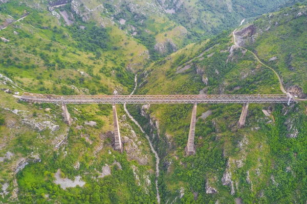 Top view of a bridge over a river in the mountains
