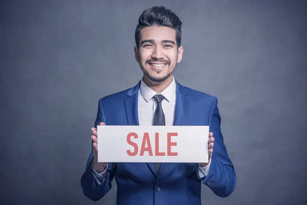 Young Attractive Man Blue Suit Holding White Sign Red Inscription — Stock Photo, Image