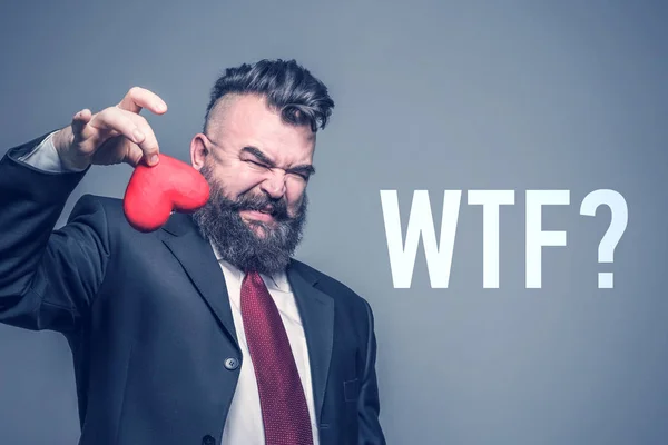 Adult Bearded Man Suit Disgust Holding Red Heart Gray Background — Stock Photo, Image