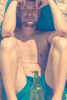 Adam bir bira ile sahilde