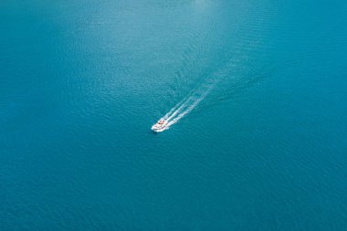 Beyaz bir teknenin mavi denizlerde yelken Üstten Görünüm