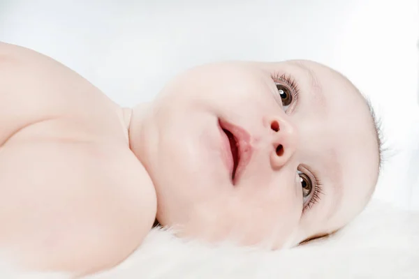 Schattige Baby Ligt Een Witte Pluizige Achtergrond — Stockfoto