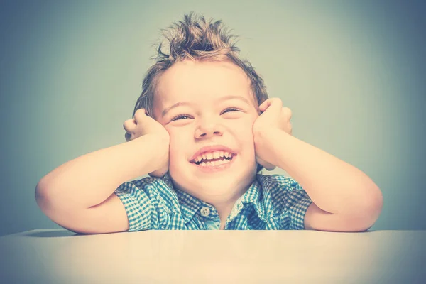 Cute Smiling Boy Blue Shirt Sitting Table Toned — Stock Photo, Image