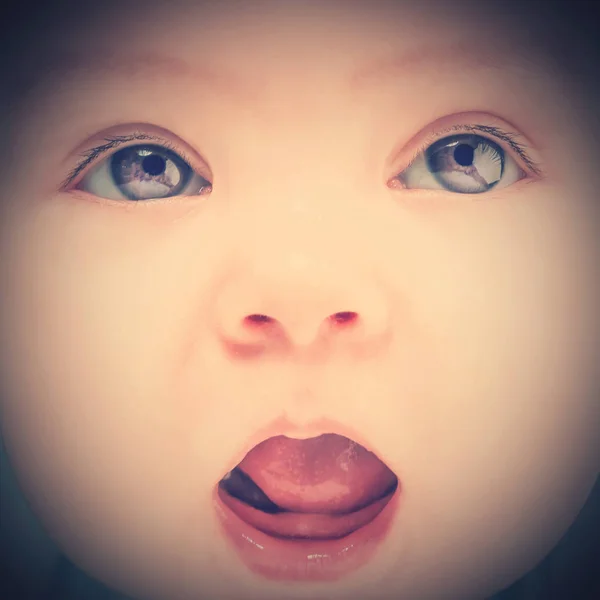 Cute baby with an open mouth, close-up. Toned