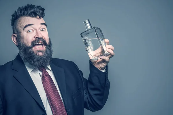 Őrült Szakállas Férfi Öltöny Kezében Egy Üveg Alkohol Egy Szürke — Stock Fotó