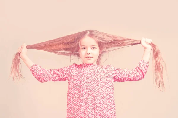 Cute Little Girl Red Dress Pulling Long Hair Different Directions — Stock fotografie