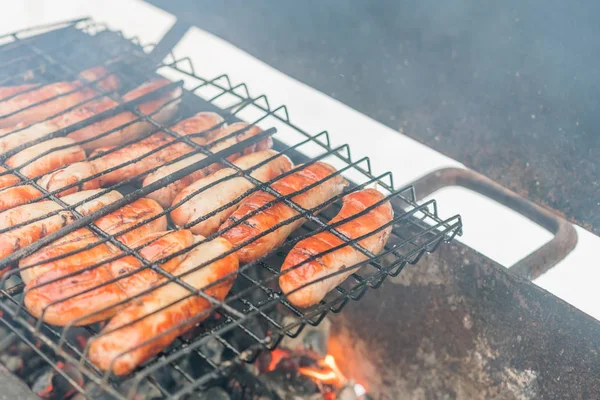 Sausages on the grill with smoke