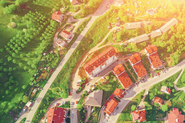 Top view of the small European city in the sunlight. Houses with tiled roofs