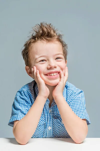 Cute Smiling Boy Blue Shirt Table Gray Background Isolated — Stock Photo, Image