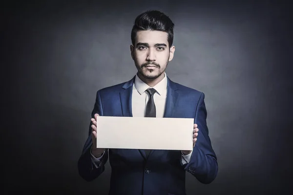 Young Attractive Man Blue Suit Holding White Sign Gray Background — Stock Photo, Image