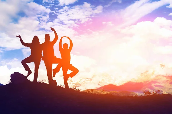 Silhouette of a group of people in the mountains at sunset