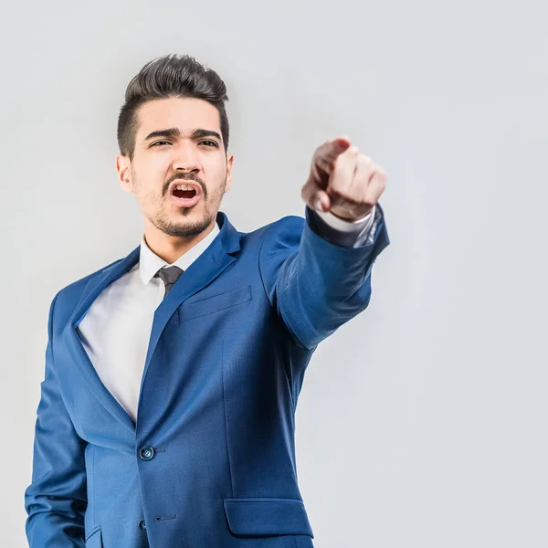 Young Attractive Man Blue Suit Showing Finger Forward Gray Background — Stock Photo, Image