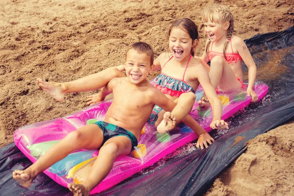 Glückliche Kinder Die Auf Der Wasserrutsche Nach Unten Rutschen Sommerferien — Stockfoto